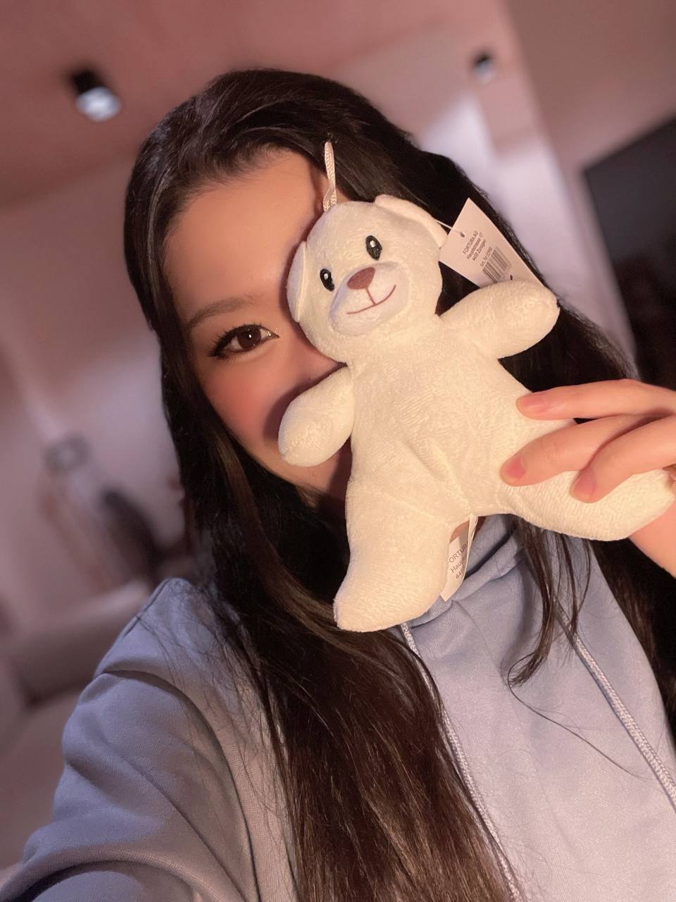 Hazu holding up Kuma-chan in front of her face